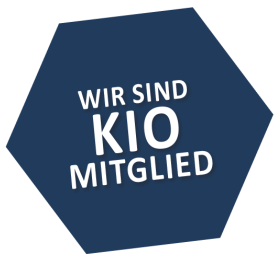 Dunkelblaues Sechseck mit dem Text: Wir sind KIO Mitglied